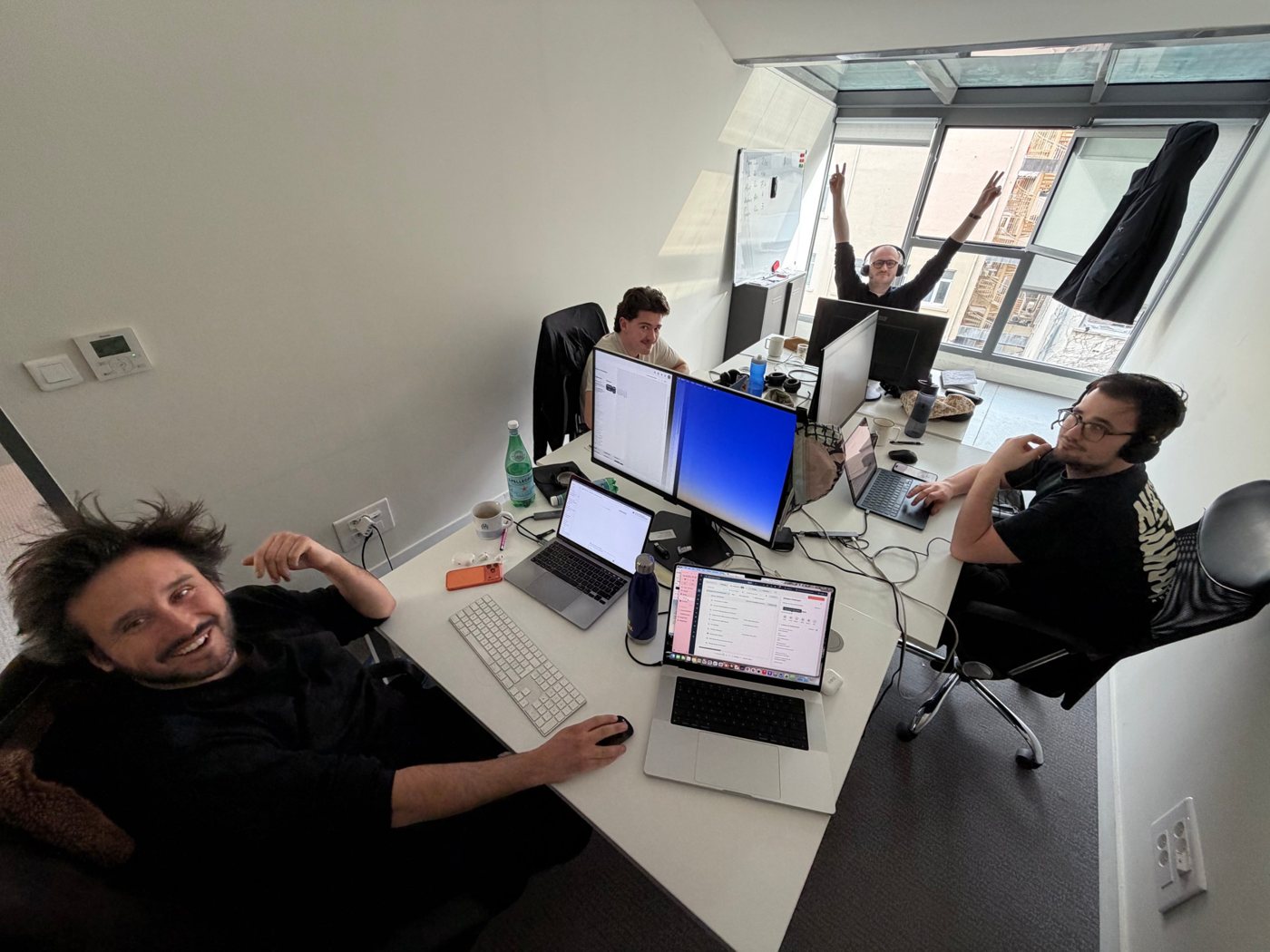 Four Hoppi team members at their desks in the office